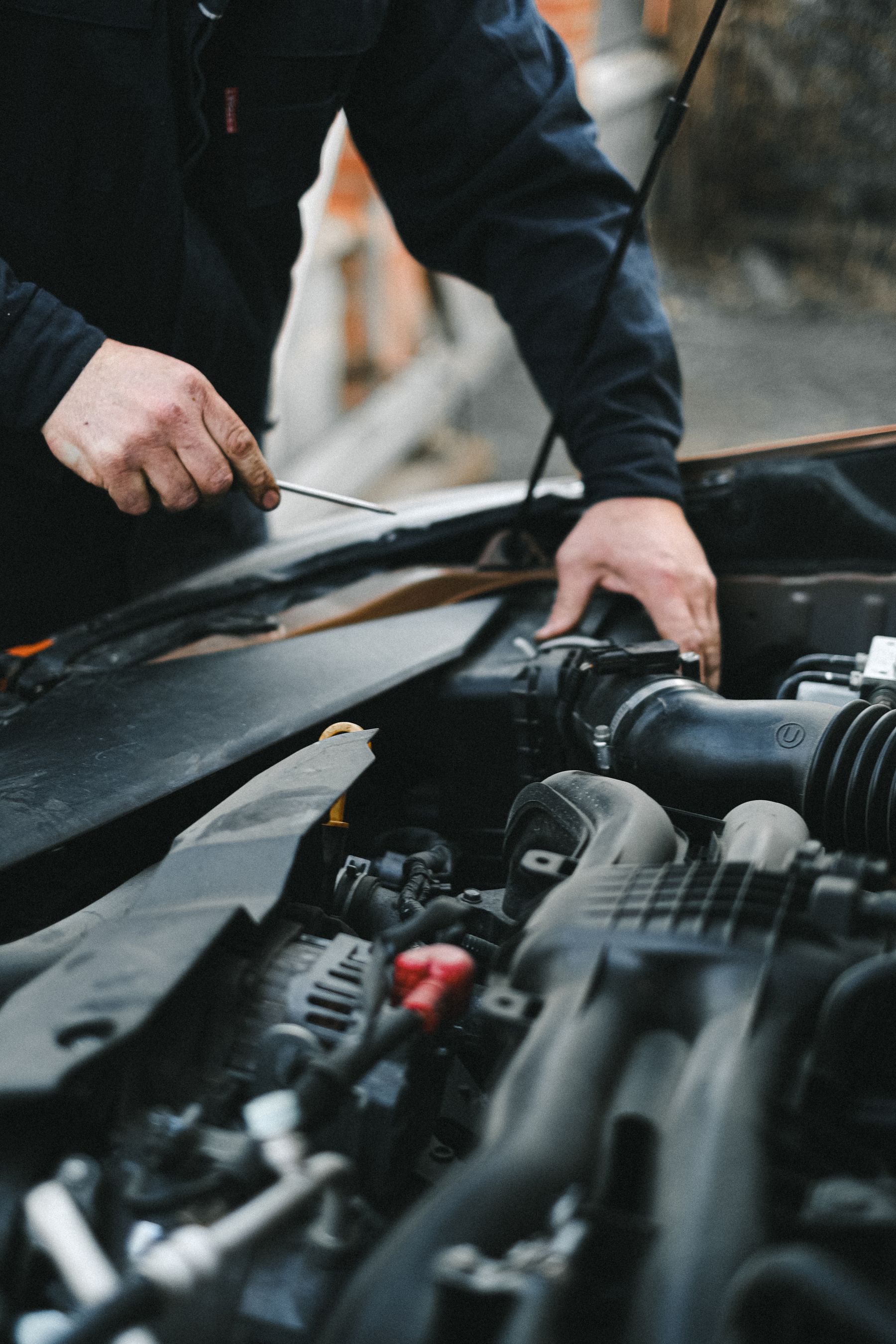 Close view of a technician inspecting a vehicle engine